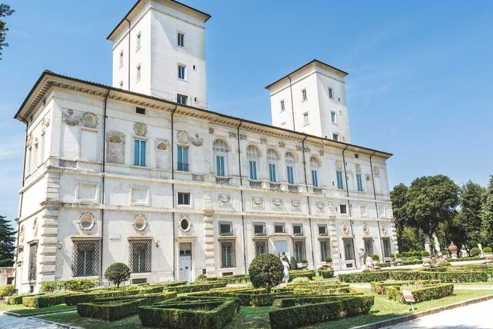 a large clock tower in front of Galleria Borghese